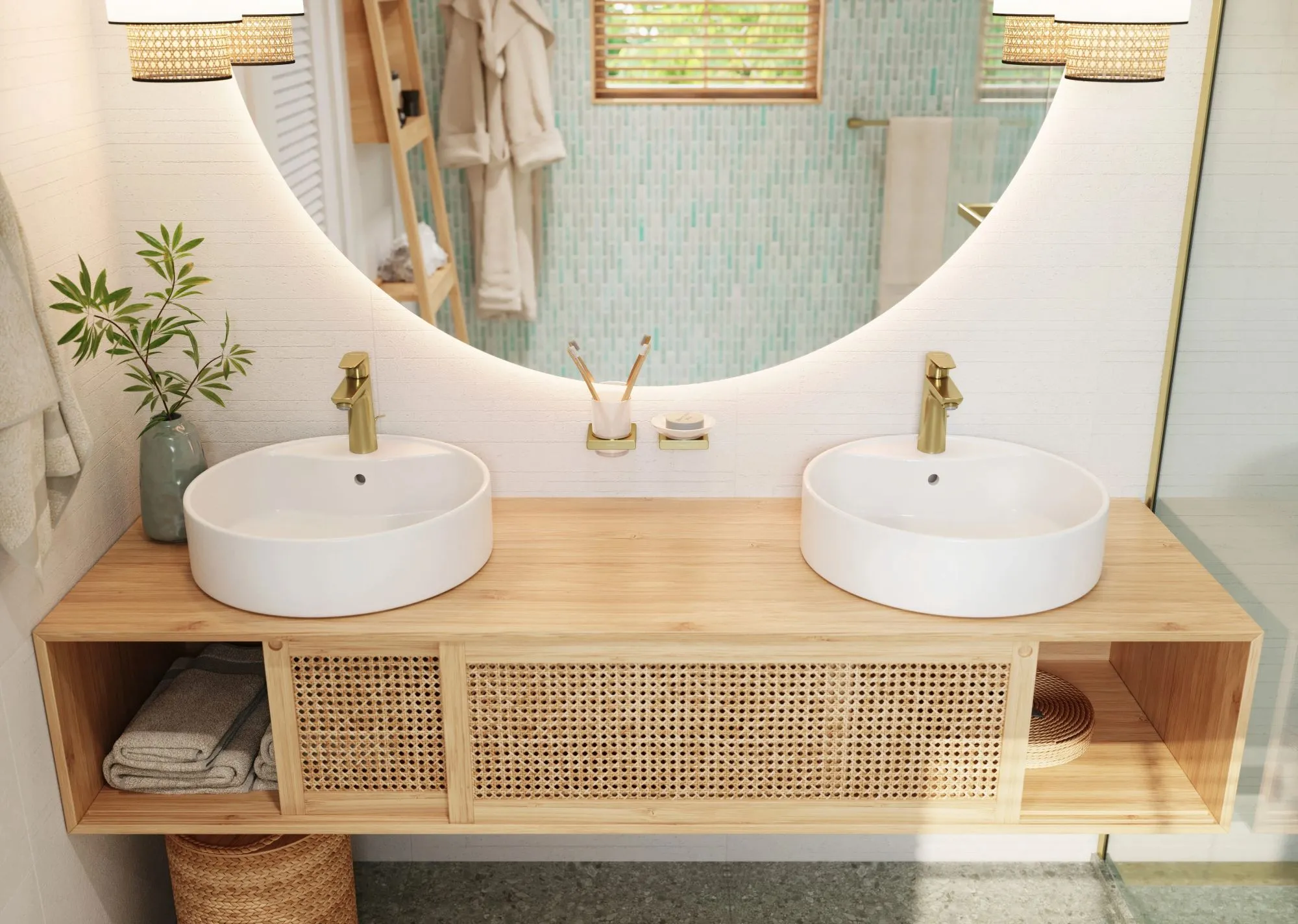 Double vessel sinks with brushed brass faucets on a light wood vanity, featuring a large backlit round mirror and rattan accents. 