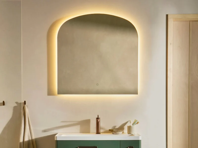 An arch-shaped LED vanity mirror above a turquoise sink.