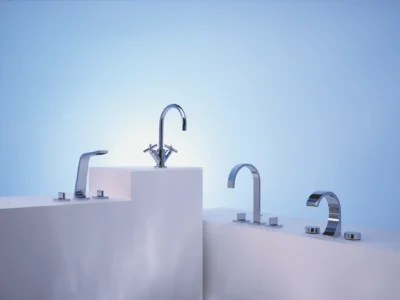 Four Dornbracht taps on display with a blue background.